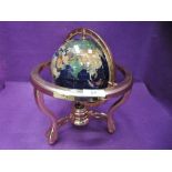 A semi precious stone effect globe with brass fittings