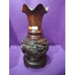 A heavy treen wood hand carved vase with mythical Oriental Dragons and sun