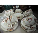 A part tea service with Deco style shape and transfer printed scene