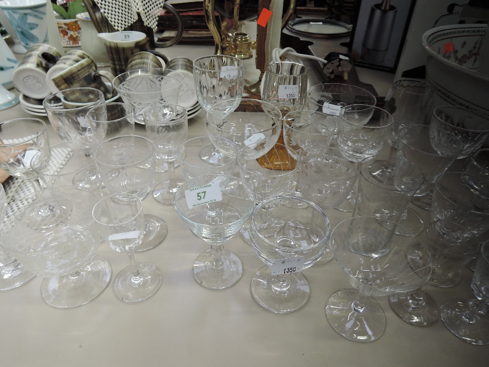 A selection of clear cut and crystal glass wares including etched sherry glasses