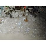 A selection of clear cut and crystal glass wares including etched sherry glasses