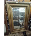 A gilt effect framed mirror with bevel edged glass