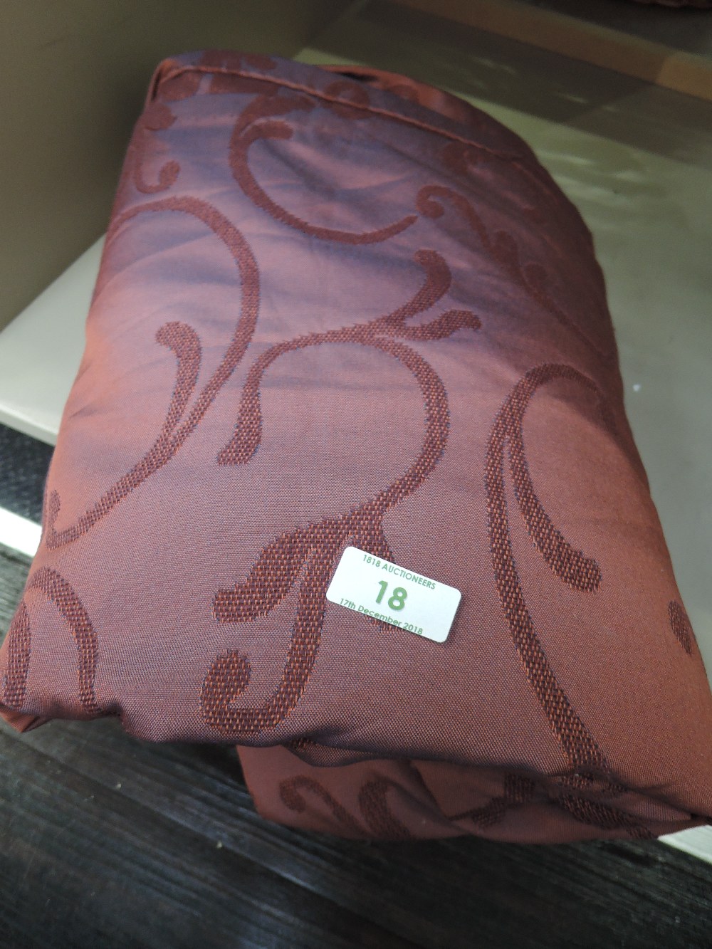A decorative throw/bedspread of poly cotton swirl design