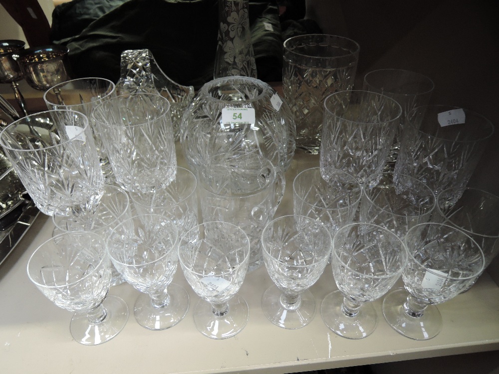 A selection of clear cut crystal glasses including etched vase