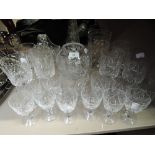 A selection of clear cut crystal glasses including etched vase