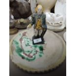 A vintage cast iron money bank modelled as 18th century gent and a Majolica style dish