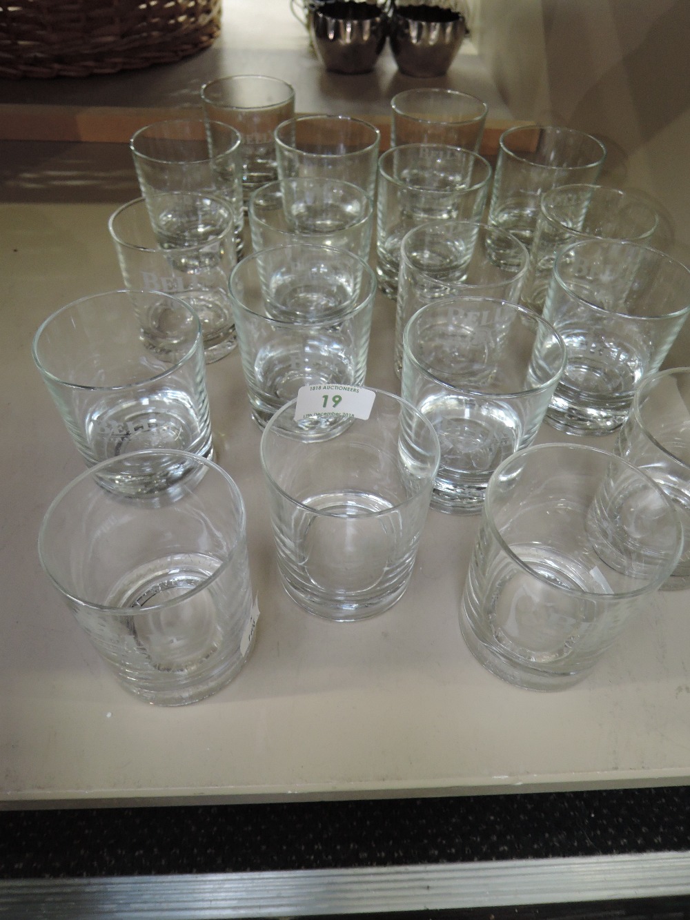 A selection of Whiskey and similar glass tumblers with etched Bells logo