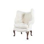 A GEORGE III WALNUT FRAMED UPHOLSTERED WING BACK ARMCHAIR, covered in a tapestry style material, and