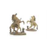 AFTER GUILLAUME COUSTOUA pair of Marly Horse groupsBrass, each 29cm high