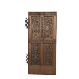 A CONTINENTAL 18TH CENTURY CARVED OAK DOOR PANEL, left hanging, with four long fielded panels