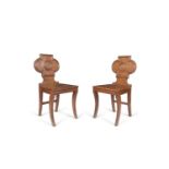 TWO SIMILAR GEORGE III MAHOGANY HALL CHAIRS, one with quatrefoil shaped back with reeded edges and