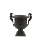 A BRONZE CAMPANA URN, the rim cast with laurel leaves above a classical frieze depicting a bacchanal