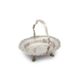 AN FINE GEORGE II SILVER SWING HANDLE BASKET, London, 1742, mark of John Luff, the raised handle