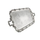 A LATE VICTORIAN SILVER PLATED SHAPED RECTANGULAR TWO HANDLED SERVING TRAY, the reserve engraved and