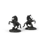 AFTER NICOLAS COUSTOU (1658-1733)A pair of bronze Marly Horses with attendant riders, on oval bases.