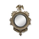 A FINE IRISH REGENCY CONVEX MIRROR, the circular mirror plate surrounded by a reeded ebon slip,