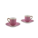 A PAIR OF ENGLISH PORCELAIN COFFEE CUPS AND SAUCERS, with a pink basket weave pattern, gilded design