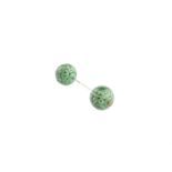 A CHINESE CARVED APPLE GREEN JADE HAT-PIN, formed as two pierced spheres, joined by a silver pin,