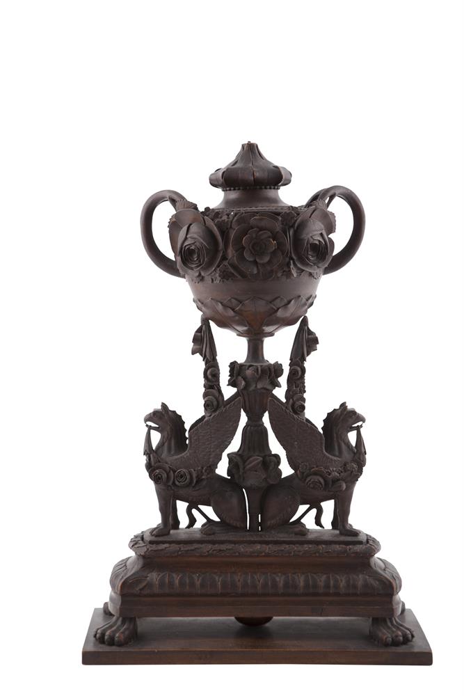 A BLACK FOREST CARVED TIMBER CENTREPIECE, formed as an urn, carved with naturalistic handles and