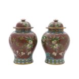 A PAIR OF CHINESE CLOISONNÉ ENAMELLED RUBY GROUND VASES AND COVERS, each with detachable top and