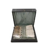 THREE SETS OF SILVER SPOONS, comprising a cased set of twelve Victorian teaspoons and matching sugar