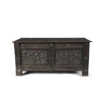 AN 18TH CENTURY STAINED OAK COFFER IN THE JACOBEAN TASTE, with two plank hinged top above a bas