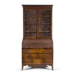 A GEORGE III MAHOGANY TAMBOUR BUREAU BOOKCASE, c.1800, the outset cornice applied with a row of