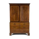 A GEORGE III MAHOGANY LINEN PRESS, c.1800, with moulded cornice above twin fielded panel doors, on a