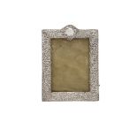 A SILVER EMBOSSED AND PIERCED EASEL BACK PHOTOGRAPH FRAME, Birmingham 1908, of rectangular form,