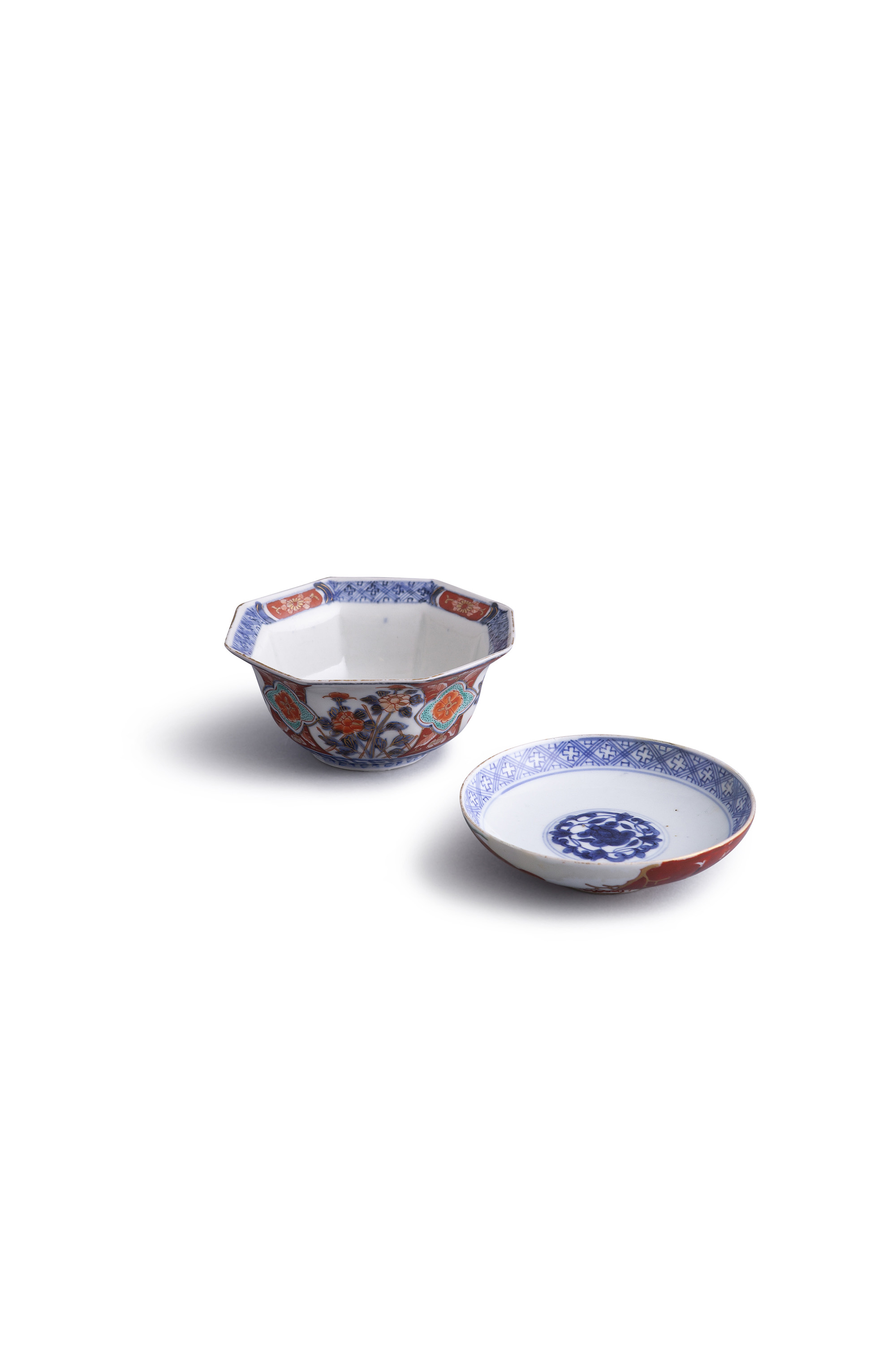 A CHINESE 'EUROPEAN SUBJECT' enamelled stand and a Japanese Imari octagonal bowl (2)