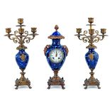 A Lot of One Porcelain Clock and Pair of Candlesticks