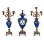 A Lot of One Porcelain Clock and Pair of Candlesticks