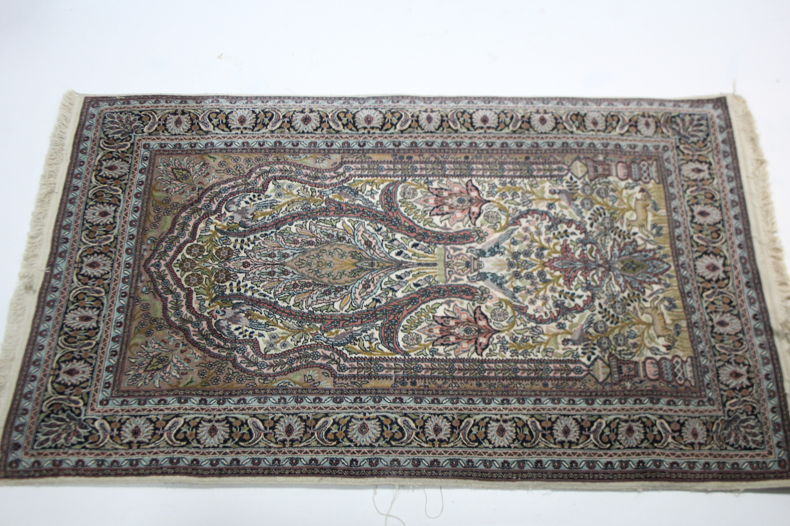 A Persian pattern rug of ivory & pale blue ground, with multi-coloured geometric, floral & animal