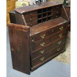 A 19th century oak bureau with fitted interior enclosed by fall-front above an arrangement of