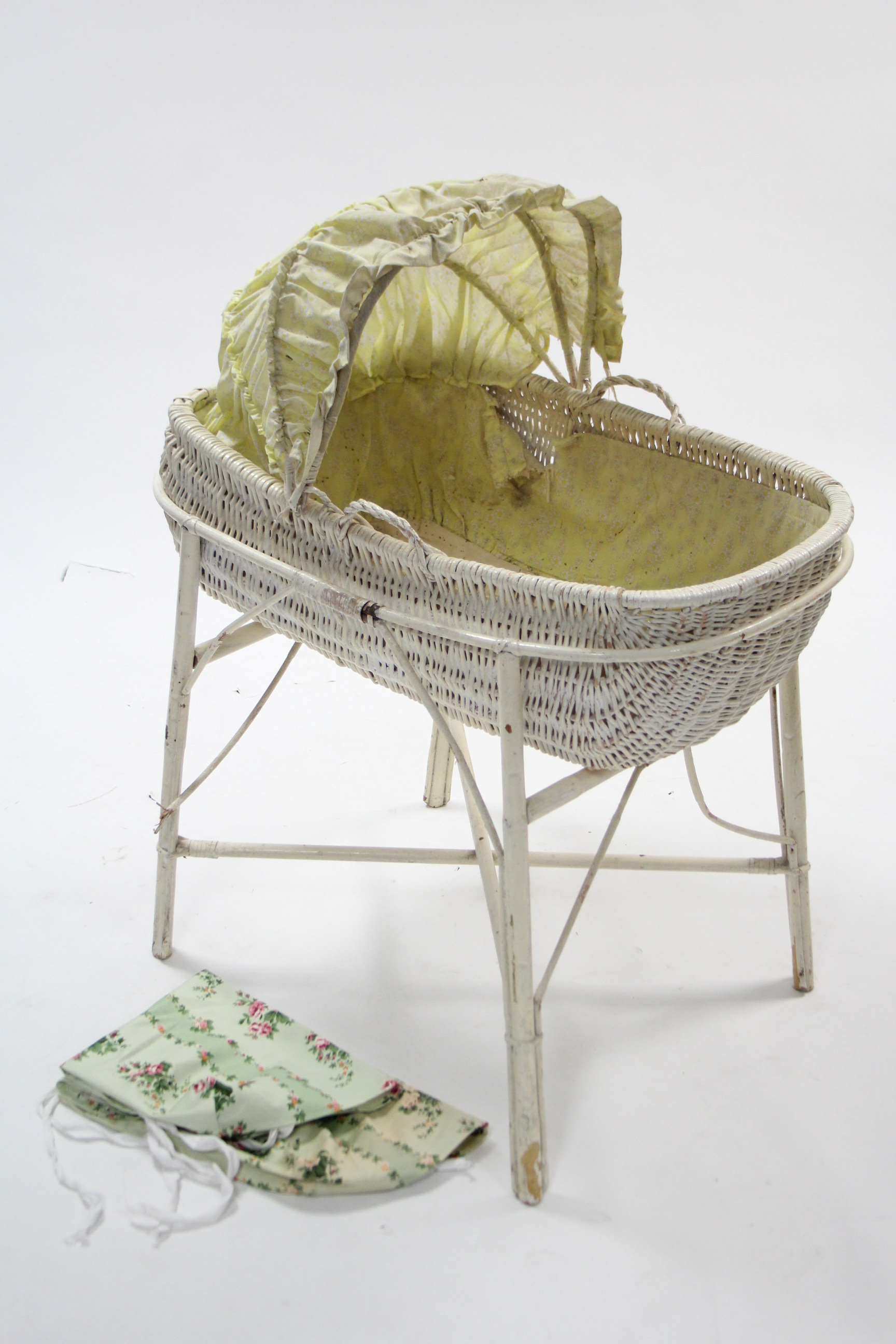 A white painted wicker baby's crib, 31½" long; together with ten various chamber pots.