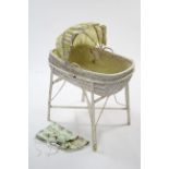 A white painted wicker baby's crib, 31½" long; together with ten various chamber pots.