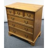 A pine chest fitted three short & three long graduated drawers with brass swing handles, & on