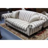 A pair of good quality three-seater settees with loose cushions to the seats & backs, upholstered