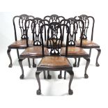 A set of six late 19th/early 20th century mahogany dining chairs with pierced & shaped splat-