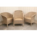 A set of four wicker tub-shaped conservatory chairs.