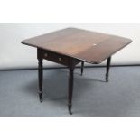 A Victorian mahogany drop-leaf table fitted end drawer & on turned tapered legs with brass