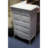 A continental-style white painted wood small chest fitted five long drawers & on short legs, 22½”