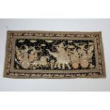 An eastern black velvet wall hanging depicting a battle scene, adorned with numerous sequins & paste