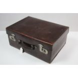 An early 20th century simulated crocodile skin leather travelling case with chrome twin-lever locks,