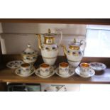 A 19th century porcelain thirteen piece part coffee service of white ground & with blue & gold
