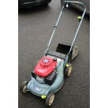 A Honda “Isy” petrol driven lawnmower with grass box.