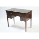 An Edwardian inlaid-mahogany kneehole writing desk inset tooled green leather cloth, fitted with