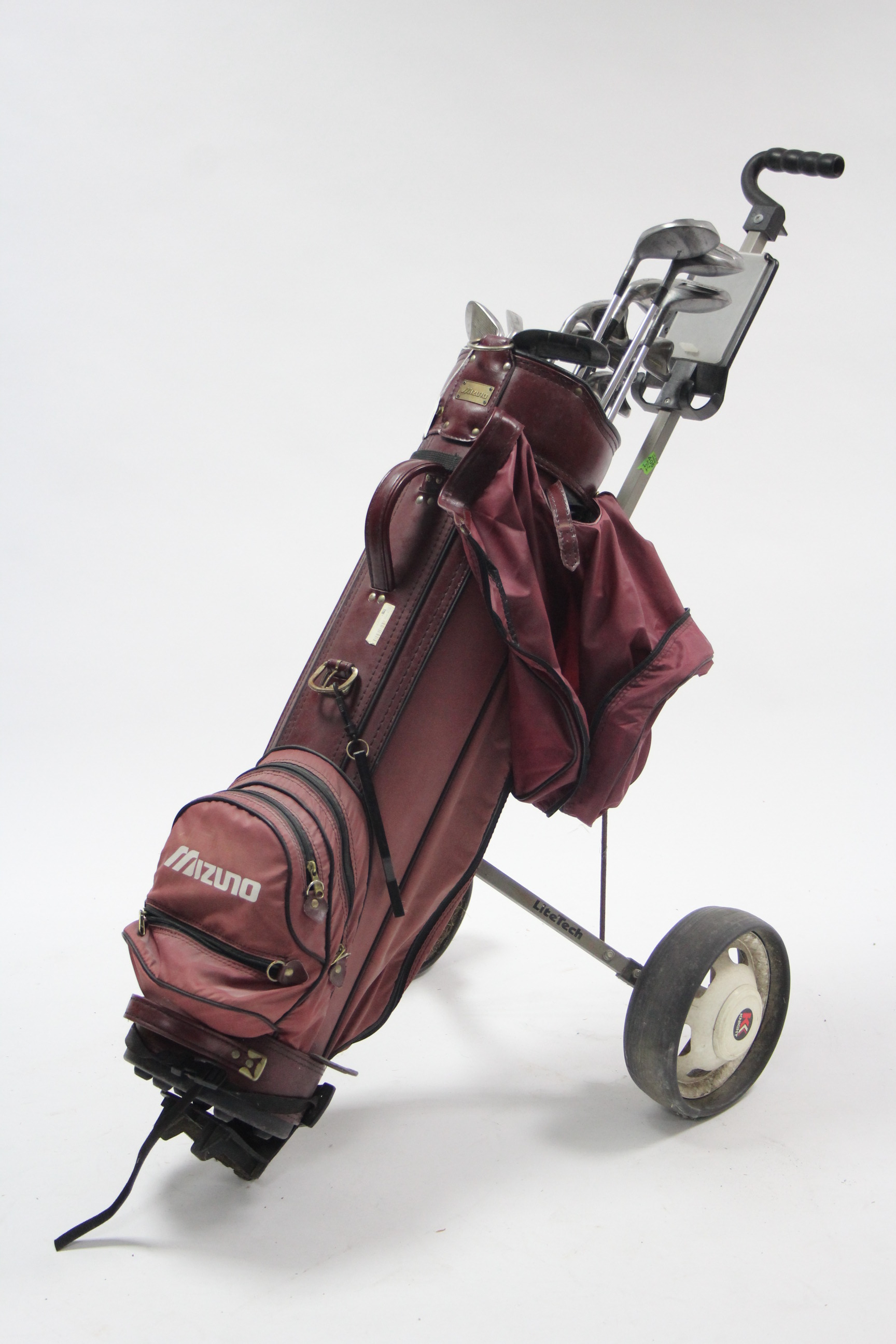 A set of thirteen MacGregors “Battlestick” left-handed golf clubs with golf club bag & trolley.