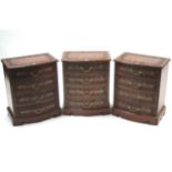 A set of three eastern-style carved hardwood & brass-inlaid four-drawer bow-front bedside chests,