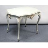 A continental-style white painted carved wood rectangular centre table on four slender cabriole legs